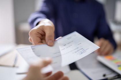 Business Person Hands Over Paycheck