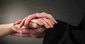 Priest Holding a Woman's Hand