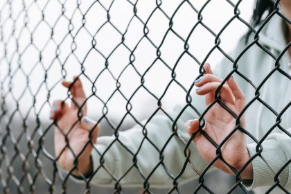 Woman Behind Fence