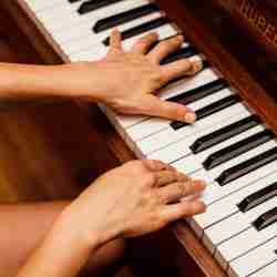 Teacher and Student Playing Piano