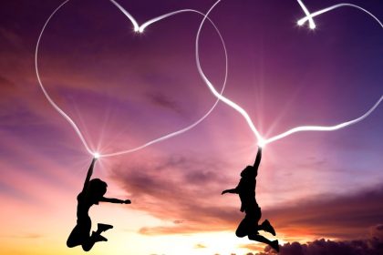 Two Happy People Jumping With Heart-Shaped Auras