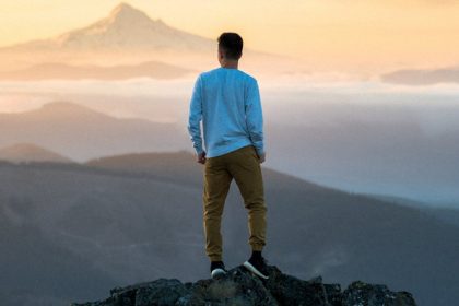 Man Looking at Mountain During Sunsent