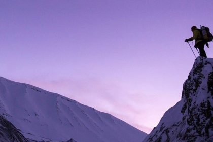 Inspiring Man Standing At Top Of Summit