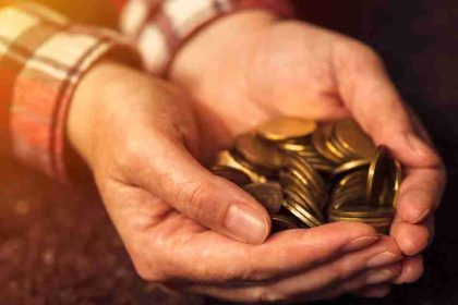 Man Holding Pennies