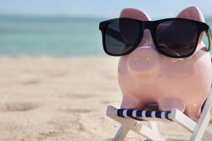 Piggy Bank Wearing Sunglasses On The Beach