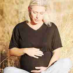 Pregnant Mom Sitting in a Golden Field