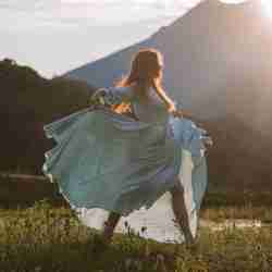 Woman Dancing Outside In White Dress