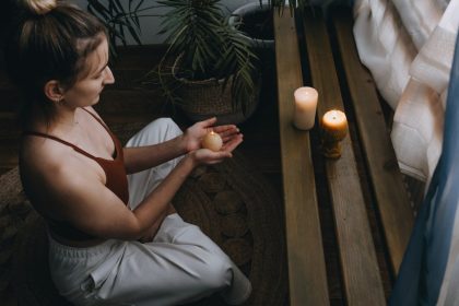 Woman Meditating With Candles