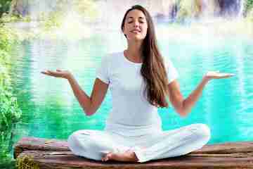 Woman Meditating by the Water