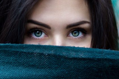 Woman Peering Over Jumper