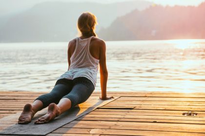 Woman Practicing Yoga by the Lake