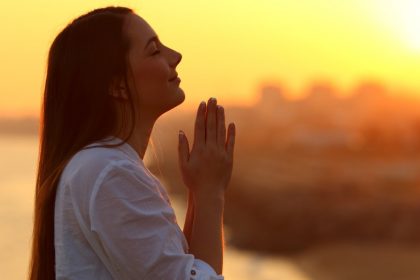 Woman Praying at Sunset