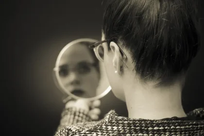 Woman Looking In Mirror