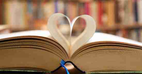 Library book opened with pages making a heart shape.