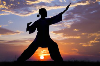 Woman Performing QIgong Xi Technique at Sunset