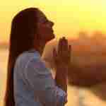 Woman Praying At Sunset